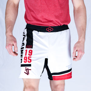model wearing white, black, and red Jordan Trained Elite Wrestling Shorts. Established 1995